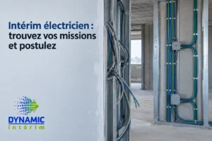 Intérieur de bâtiment en construction avec des câbles électriques apparents et un tableau de câblage vertical.